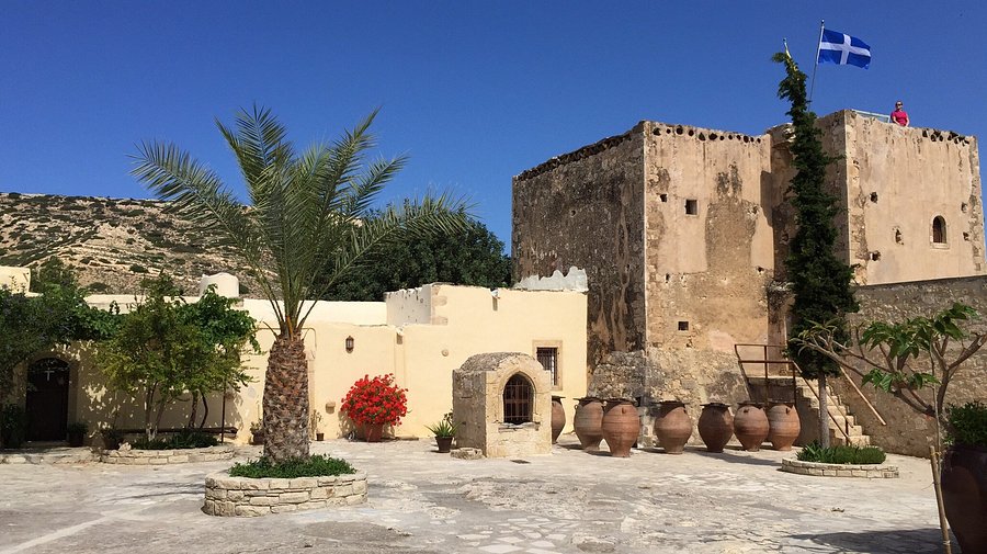 The Odigitria Monastery in South Crete, featuring its fortified tower, stone buildings, courtyard and traditional clay jars