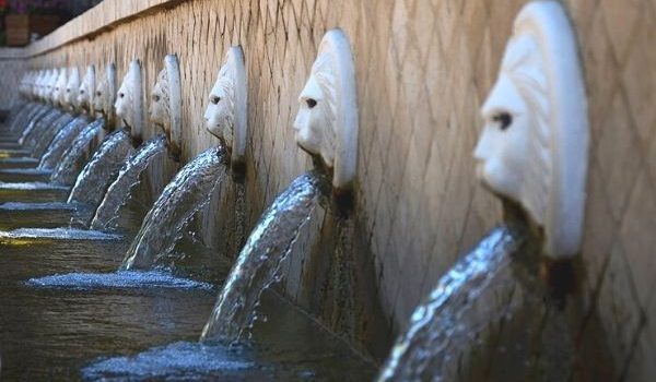 The famous lion-head fountains of Spili village, Crete, with crystal-clear spring water flowing from 25 stone spouts