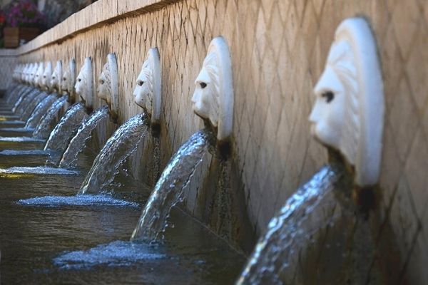 The famous lion-head fountains of Spili village, Crete, with crystal-clear spring water flowing from 25 stone spouts