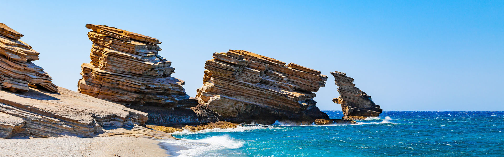 Triopetra beach in South Crete with its three iconic rock formations in the sea